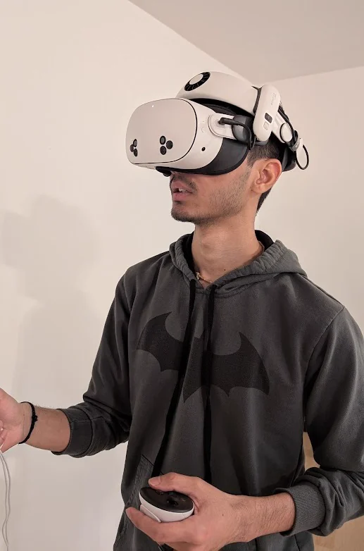 Arshit Vaghasiya in a VR headset, holding a controller